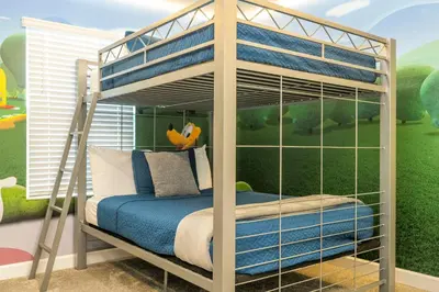 a bunk bed with a ladder in a bedroom at Disney adventure resort style free waterpark2633 in Kissimmee