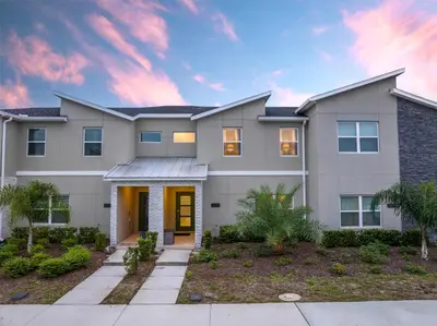 a home at sunset with a driveway at Disney adventure resort style free waterpark2633 in Kissimmee