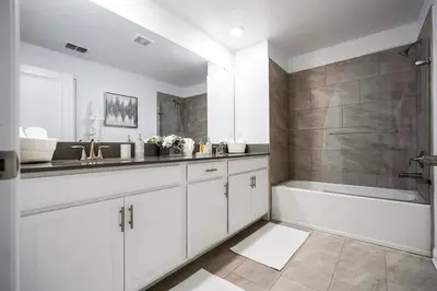 a white bathroom with a tub and a sink and a shower at Luxury 5BR Storey Lake Retreat Near Disney 2969 in Kissimmee