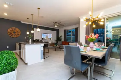 a dining room and living room with a table and chairs at Luxury 4Bed Near Disney, FreeVIP Resort 4335 in Kissimmee