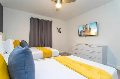 a bedroom with two beds and a dresser at Luxury 4Bed Near Disney, FreeVIP Resort 4335 in Kissimmee