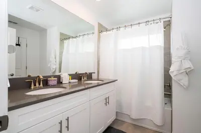 a bathroom with two sinks and a shower at Lake view & Free Resort Access near Disney 4399 in Kissimmee