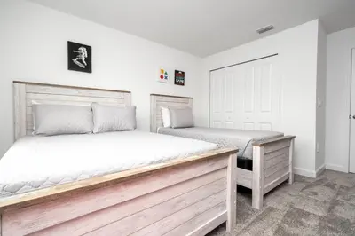 two beds in a bedroom with white walls at Lake view & Free Resort Access near Disney 4399 in Kissimmee