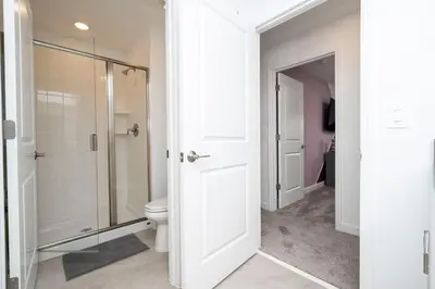 a bathroom with a toilet and a glass shower at Lake view & Free Resort Access near Disney 4399 in Kissimmee