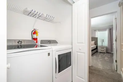 a white kitchen with a stove and a dishwasher at Lake view & Free Resort Access near Disney 4399 in Kissimmee