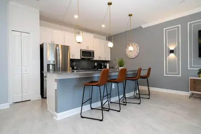 a kitchen with a table with chairs and a refrigerator at Stylish home Near Disney Free Waterpark 4407 in Kissimmee
