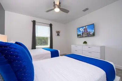 a bedroom with two beds and a ceiling fan at Stylish home Near Disney Free Waterpark 4407 in Kissimmee