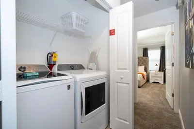a white kitchen with a stove and a sink at Stylish home Near Disney Free Waterpark 4407 in Kissimmee