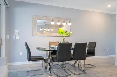 a dining room with a table and black chairs at Cozy home Near Disney Free resort Access 4463 in Kissimmee