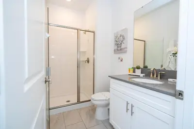 a bathroom with a shower and a toilet and a sink at Cozy home Near Disney Free resort Access 4463 in Kissimmee