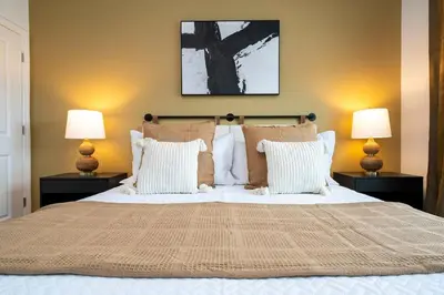 a bedroom with a large bed with two lamps at Pro decor Disney Resort style FREE Waterpark 4467 in Kissimmee