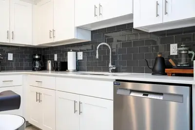 a kitchen with white cabinets and a stainless steel dishwasher at Resort Condo Near Disney FREE Waterpark 4721 in Kissimmee
