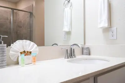 a bathroom counter with a sink and a mirror at Resort Condo Near Disney FREE Waterpark 4721 in Kissimmee