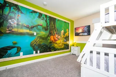 a bedroom with a mural of a forest at lion king affordable home & free waterpark 4913 in Kissimmee