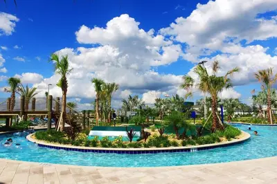 a pool at a resort with palm trees at lion king affordable home & free waterpark 4913 in Kissimmee