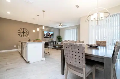 a kitchen and dining room with a table and chairs at Gorgeus HOUSE Near Disney & FREE water park 4963 in Kissimmee