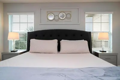 a bedroom with a bed with two pillows and two lamps at Gorgeus HOUSE Near Disney & FREE water park 4963 in Kissimmee