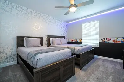 a bedroom with two beds and a ceiling fan at Gorgeus HOUSE Near Disney & FREE water park 4963 in Kissimmee