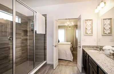 a bathroom with a shower and a sink and a mirror at Gorgeous Vacation Home near Everywhere in Kissimmee