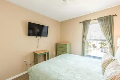 a bedroom with a bed and a flat screen tv at Townhome at Emerald Island Resort in Kissimmee