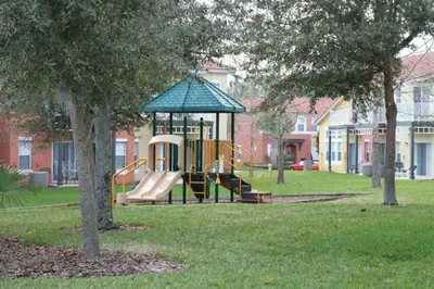 a playground with a slide in a park at Townhome at Emerald Island Resort in Kissimmee