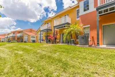 a row of houses with a lawn in front at Townhome at Emerald Island Resort in Kissimmee
