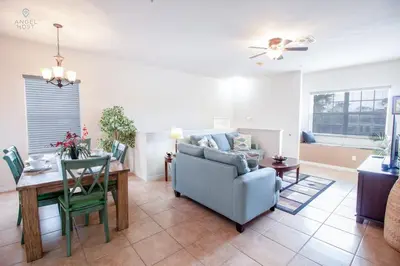 a living room with a blue couch and a table at Townhome at Oakwater Resort in Orlando