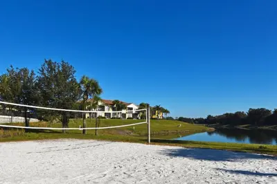 a volleyball court on a beach next to a river at Townhome at Oakwater Resort in Orlando