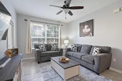 a living room with two couches and a ceiling fan at 7671 Comrow Unit 205 in Kissimmee