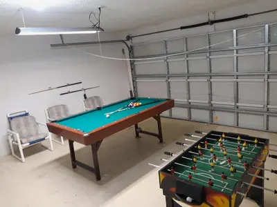a room with a pool table and chairs at Three-Bedroom House in Clear Creek in Orlando