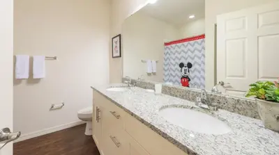 a bathroom with two sinks and a toilet at Townhome at West Lucaya Resort 3212 in Orlando