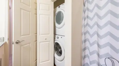a laundry room with a washer and dryer next to a door at Townhome at West Lucaya Resort 3212 in Orlando