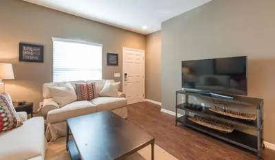 a living room with a couch and a flat screen tv at Townhome at West Lucaya Resort 3212 in Orlando