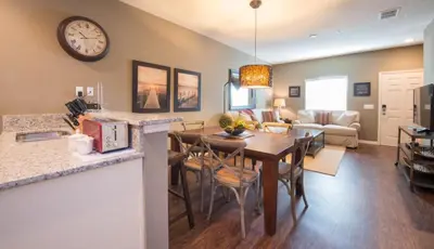 a kitchen and living room with a table and a clock at Townhome at West Lucaya Resort 3212 in Orlando