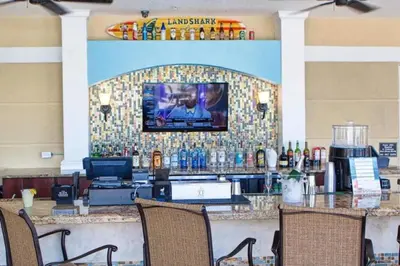 a bar in a restaurant with a tv on a wall at Apartment at Vista Cay Resort in Orlando