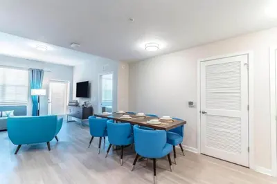 a dining room with a table and blue chairs at Apartment at Vista Cay Resort in Orlando