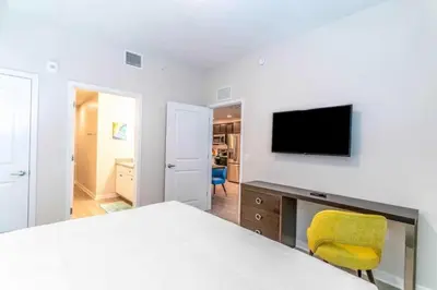 a bedroom with a bed and a tv on a wall at Apartment at Vista Cay Resort in Orlando