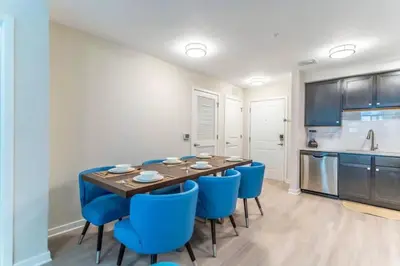 a dining room with a table and blue chairs at Apartment at Vista Cay Resort in Orlando