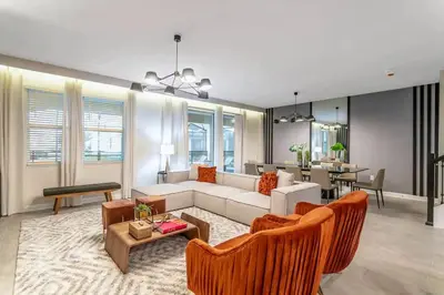 a living room with a couch and chairs and a table at Private Pool and Spa Home at Storey Lake Resort in Kissimmee