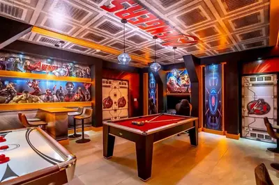 a game room with a pool table and a arcade at Private Pool and Spa Home at Storey Lake Resort in Kissimmee