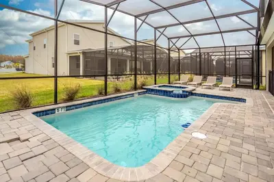 a large swimming pool with a clear cover over it at Private Pool and Spa Home at Storey Lake Resort in Kissimmee
