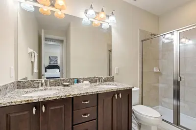 a bathroom with a sink and a toilet and a shower at 11 bd home Movie Room Close to Disney Sleeps 24 in Orlando