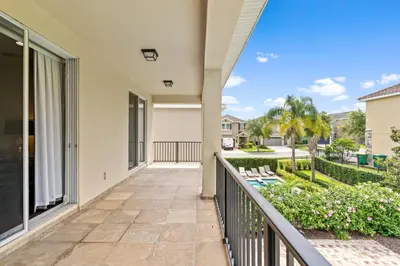 a balcony with a view of a yard at 11 bd home Movie Room Close to Disney Sleeps 24 in Orlando