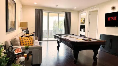 a living room with a pool table in it at 11 bd home Movie Room Close to Disney Sleeps 24 in Orlando
