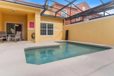 a swimming pool in the backyard of a house at 8960 Cat Palm Road in Kissimmee