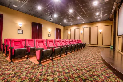a conference room with red chairs and a table at 8960 Cat Palm Road in Kissimmee