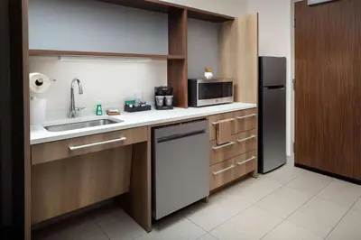 a small kitchen with a sink and a refrigerator at Home2 Suites By Hilton Lake Mary Orlando in Lake Mary