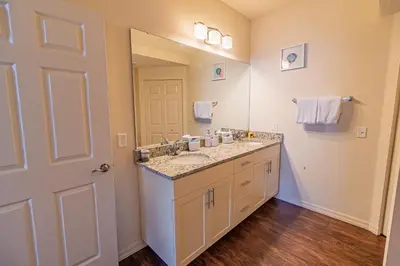 a bathroom with a sink and a mirror at New in the market townhouse in West Lucaya! in Kissimmee