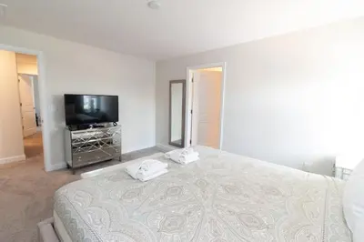 a bedroom with a bed and a flat screen tv at Private Pool Townhome at Storey Lake Resort in Kissimmee