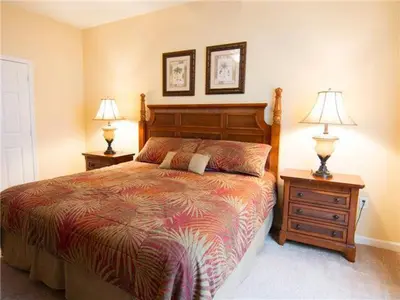 a bedroom with a bed and two night stands with lamps at Apartment at Vista Cay Resort in Orlando